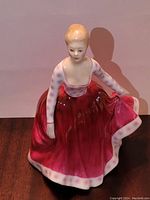 Front view of Royal Doulton Fiona porcelain figurine showcasing the red dress and facial details.