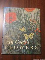Front cover of 'Van Gogh's Flowers' hardcover book showing floral and butterfly artwork.