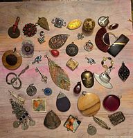 Wide flat lay of mixed charms and pendants with various materials and shapes shown clearly