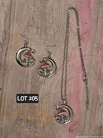 Photo of mushroom moon costume jewelry set including necklace and earrings on wooden surface.