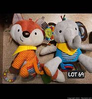 Two plush Skip Hop Bandana Buddies multi-sensory toys, a fox and an elephant, displayed side-by-side showing the full toys and their details.