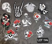 Top-down view of 12 embroidered patches arranged in three rows on floral patterned surface.