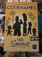 Front of the game box with silhouettes of The Simpsons family characters, title and branding