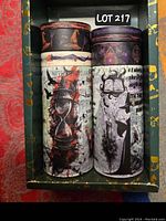 Box with 8 washi tape rolls, showing front designs of the tapes with witchy motifs including hourglass, witches, and spell symbols.