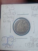 Obverse side of 1853 Seated Liberty One Dime silver coin with visible date and seated Liberty figure.