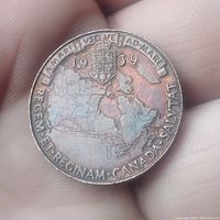 Reverse side of the coin depicting a map of Canada under a shield with Latin inscriptions and the year 1939.