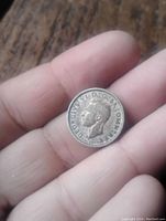 Obverse side showing King George VI profile and inscription.