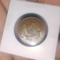 Close-up image of the 1952 UK half penny coin showing the sailing ship design with the year and denomination clearly visible, in a white protective holder.