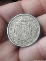 Reverse of the 1960 English half crown coin showing crowned shield with Royal Arms and inscriptions.