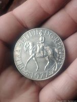 Obverse side of the coin showing Queen Elizabeth II on horseback with the 1977 date and inscription.