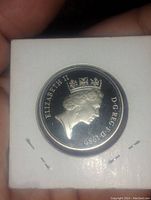 Obverse side of the coin showing Queen Elizabeth II's profile with the inscription 'ELIZABETH II D.G.REG.F.D.1989'. Coin housed in a protective cardboard flip.