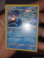 Front of the Alolan Ninetales holo Pokemon card showing the full holographic image, text, and details.
