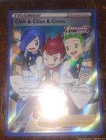 Photo of the full art holo foil Pokemon Trainer card featuring Chili, Cilan, and Cress with Fusion Strike logo in the upper right.