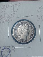 Obverse view of 1914 Barber dime showing Lady Liberty profile and inscription 'UNITED STATES OF AMERICA 1914'. Coin secured in 2x2 cardboard holder with handwritten notes.