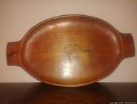 Top-down view of the oval pine dough bowl showing its smooth interior and natural wood grain with handles on both ends.
