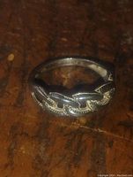 Close-up photo showing the rope link design and the wear on the sterling silver surface.