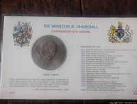 Full view of coin sealed in original paper packaging showing text and imagery related to Sir Winston S. Churchill and coin details.