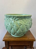 Front view of sea-foam green glazed ceramic planter with diamond quilt relief pattern