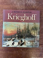 Front cover of the hardcover coffee table book featuring winter landscape artwork and title details.