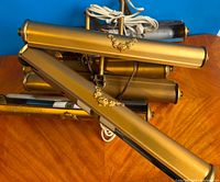 Six vintage brass portable electric lamps arranged with cords visible