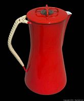 Front view of red enameled percolator pot with lid and handle