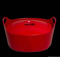 Front view of red enameled cast iron pot with lid in place