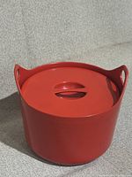 Closed red pot with lid in front view