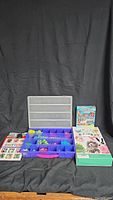 Full lot image showing all four kids craft kits and supplies: elastic bracelet kit in organizer tray, boxed suncatcher paintable kit, mitten decoration kit sheet, and woolly pets yarn critters box.