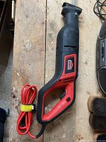JobMate reciprocating saw with the power cord wrapped and secured beside the handle, showing tool body and logo clearly.