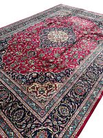 Full view of rug laid flat showing central medallion and border pattern