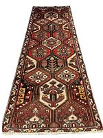 Full view of the long narrow Persian Bakhtiari rug showing multiple patterned bricks with diverse floral and animal motifs in red, cream, and brown tones.