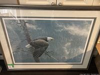Front view of framed Robert Bateman print depicting bald eagle perched on branch against mountain background
