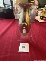 Front view of the vintage mid-century modern vase showing the solid metal elongated body framed by two flat glass panels.