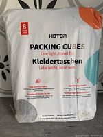 Front packaging of HOTOR packing cube set showing 8 pieces included, product features high density fabric and quality zipper