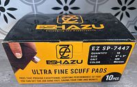 Closed box of EShazu Ultra Fine Scuff Pads with label showing quantity 10, size 6" x 9", grit 320, maroon color.
