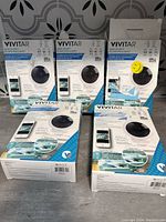 Five Vivitar Smart Security Cameras in their retail packaging, displayed on a surface.