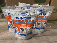 Five ProPac Winter Warm Up Kit pouches arranged on a surface, showing front labels and packaging design.