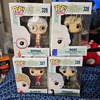 Photo showing four boxed Funko Pop vinyl figures of The Golden Girls characters: Sophia, Rose, Blanche, Dorothy.
