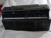 Full front view of the vintage Magnavox D8300 dual cassette boombox showing both cassette decks, radio tuner, and speaker grills.