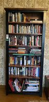Full front view of the bookcase loaded with books