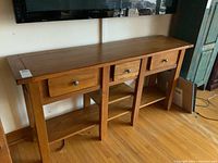 Full front view of the console table under a wall-mounted TV
