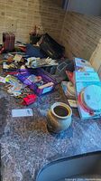 Overview of the lot showing organizational baskets, various tapes, writing utensils, smoke and carbon monoxide detectors, and small household items on countertop.