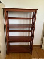 Full front view of solid wood shelf unit with four shelves.