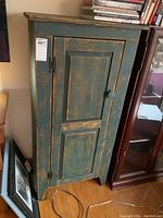 Front view of painted pine cupboard showing door and distressed finish