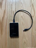 Hitachi external hard drive connected to USB cable, showing included accessories