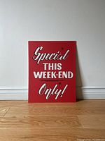 Full view of rectangular vintage wooden sign with red background and white lettering 'Special THIS WEEK-END Only!'.