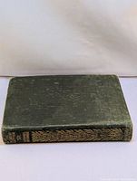 Top view of the book showing the spine and front cover with gilt decoration and title.