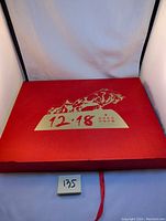 Photo of the red outer box featuring gold bull motif and the text '12.18' in Chinese with accompanying characters.