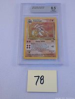 Front view of holographic Kabutops card in Beckett slab graded 8.5 near mint mint+.
