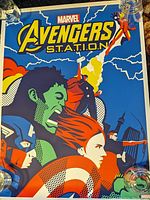 Front view of the Marvel Avengers poster showing colorful stylized superhero characters and the title.